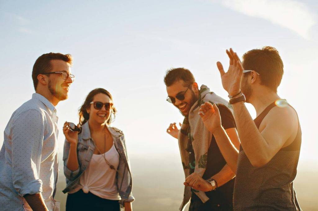 Group of friends enjoying their time outdoors, laughing and having fun in the sunlight.